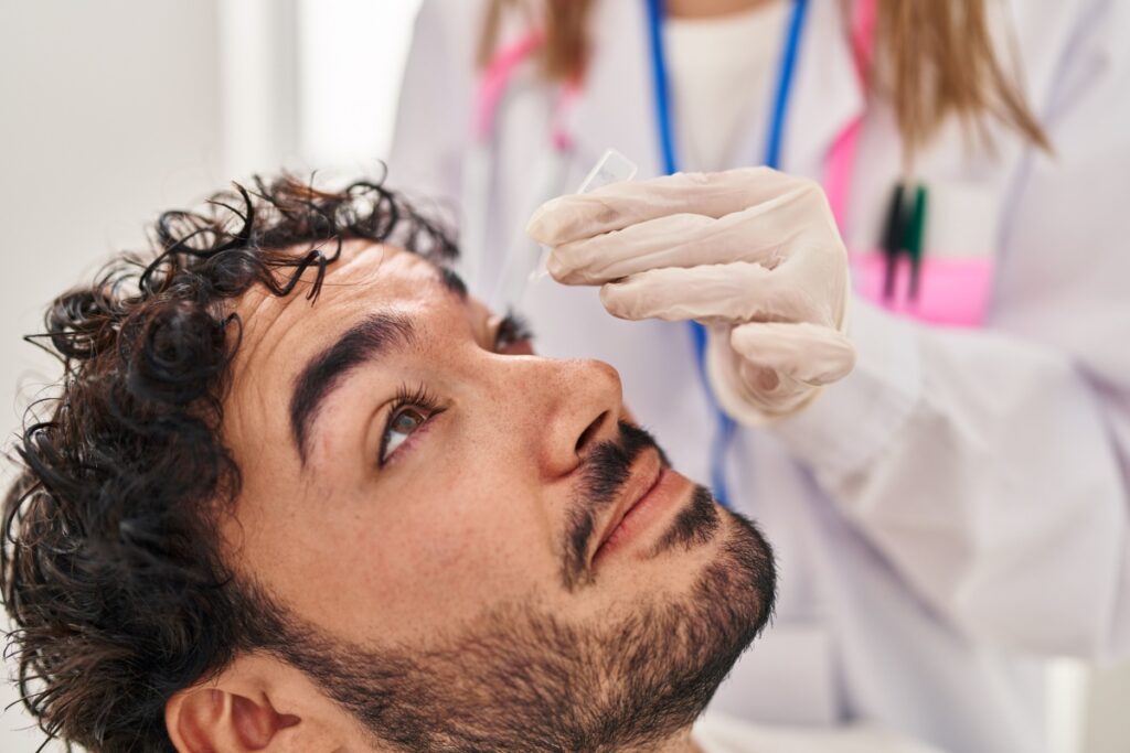 An eye doctor administers artificial tears to ease a patient's dry eye symptoms.